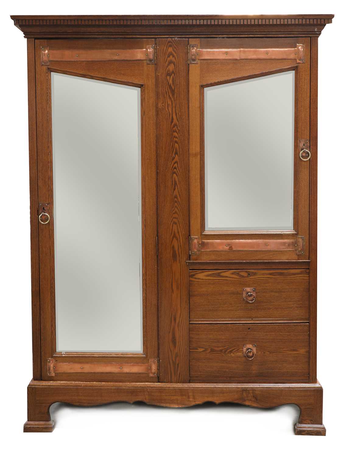 Lot 59 - An Arts and Crafts oak mirrored wardrobe