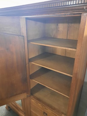 Lot 59 - An Arts and Crafts oak mirrored wardrobe