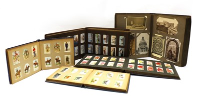 Lot 159 - A collection of various postcards in four albums