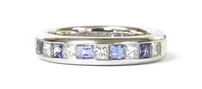 Lot 170 - An 18ct white gold tanzanite and diamond half eternity ring