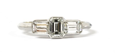 Lot 113 - A platinum three stone emerald cut diamond ring