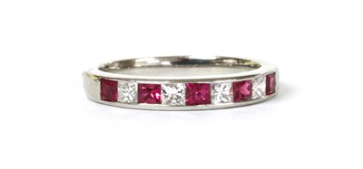 Lot 138 - A platinum ruby and diamond half eternity ring