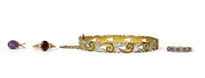 Lot 283 - A 9ct gold amethyst and diamond ribbon half eternity ring