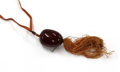 Lot 33 - A cherry coloured Bakelite bead pendant