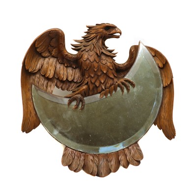 Lot 102 - A Black Forest carved limewood mirror