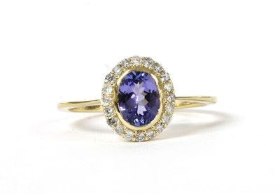 Lot 173 - A gold tanzanite and diamond cluster ring