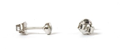 Lot 110 - A pair of white gold single stone diamond stud earrings