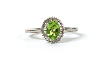 Lot 194 - A white gold peridot and diamond cluster ring