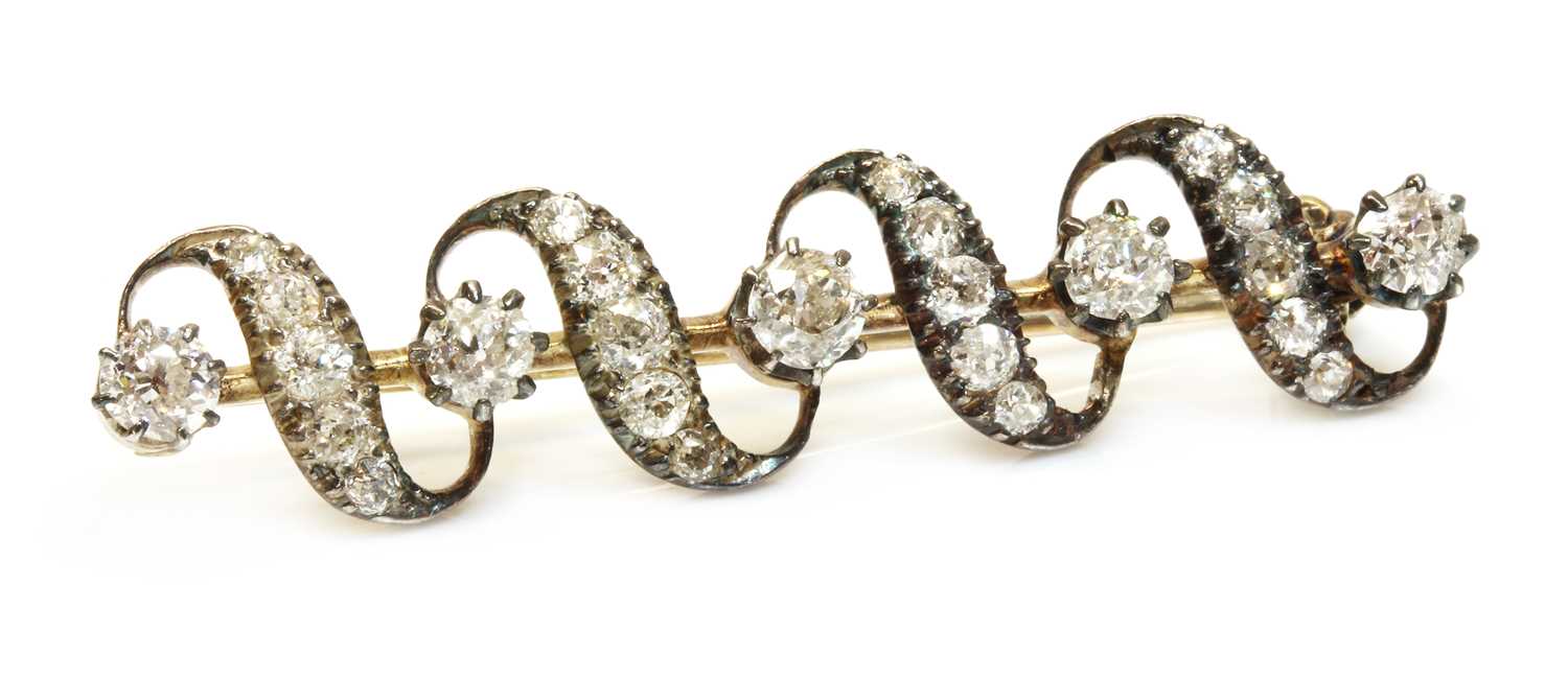Lot 47 - A late Victorian diamond set ribbon bar brooch, c.1880