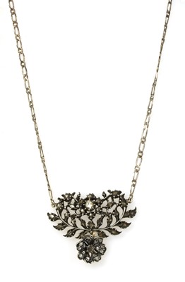 Lot 103 - A silver and gold, diamond set pendant