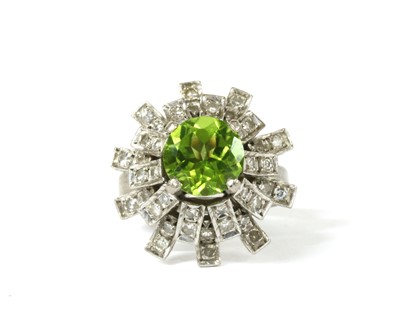 Lot 193 - A white gold peridot diamond cluster ring
