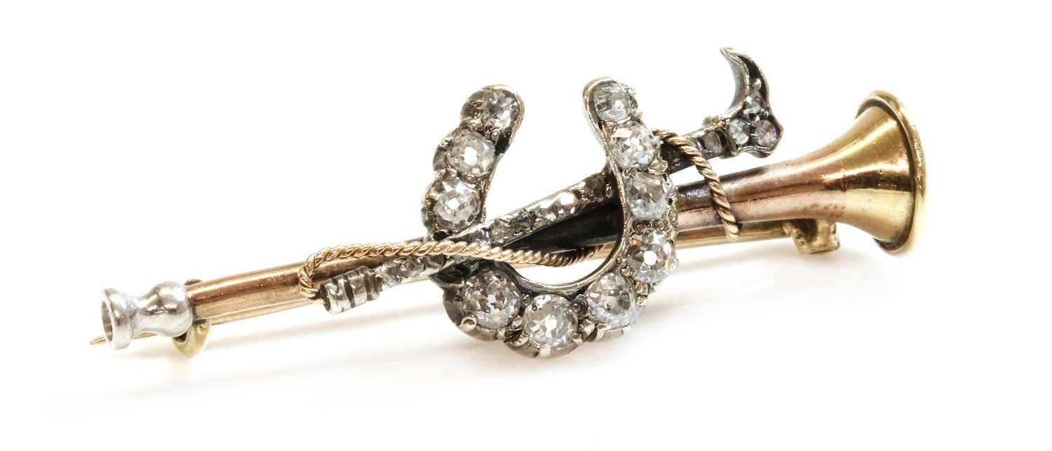 Lot 49 - A cased diamond set hunting horn, horseshoe and crop bar brooch, c.1900
