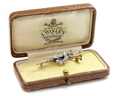Lot 49 - A cased diamond set hunting horn, horseshoe and crop bar brooch, c.1900