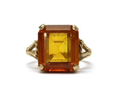 Lot 1241 - A gold single stone synthetic orange sapphire ring