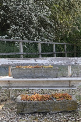 Lot 781 - A near pair of carved stone troughs