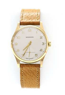 Lot 233 - A gentlemen's 9ct gold Garrard mechanical strap watch