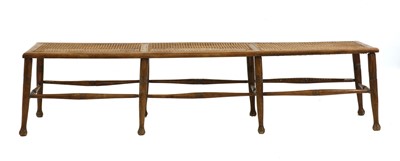 Lot 369 - A beech and wicker topped long stool