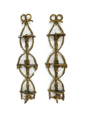 Lot 191 - A pair of vertical hanging gilt wall shelves