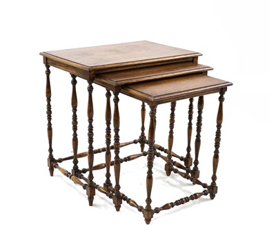 Lot 485 - A nest of three oak occasional tables