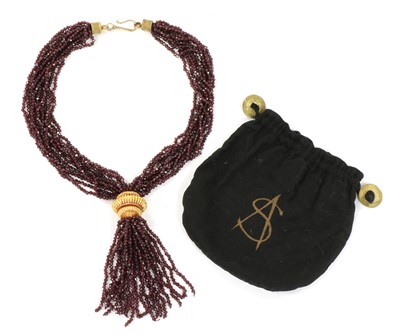 Lot 117 - A gold and silver, garnet tassel necklace, by Sandra D'Auriol