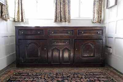 Lot 210 - An oak dresser with cupboards and drawers