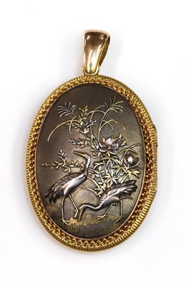 Lot 83 - A Shakudo double sided oval hinged locket, c.1880