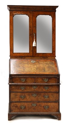 Lot 585 - A walnut bureau bookcase