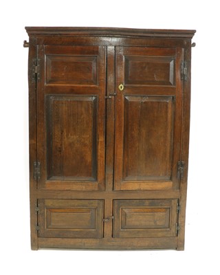 Lot 425 - A panelled oak cupboard