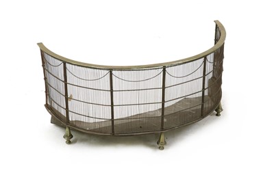 Lot 392 - A Regency wirework and brass demi-lune fire surround
