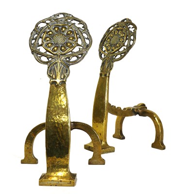 Lot 94 - A pair of Arts and Crafts pierced brass firedogs