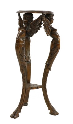 Lot 376 - A continental carved walnut and beech torchere