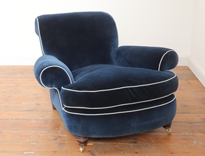 Lot 595 - A deep-seated Howard-style armchair