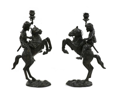 Lot 375 - A pair of patinated bronze oil lamps