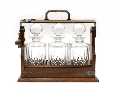 Lot 184 - A walnut and silver plated tantalus