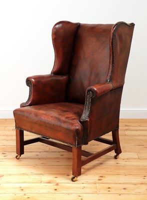 Lot 560 - A George III mahogany-framed leather wingback armchair
