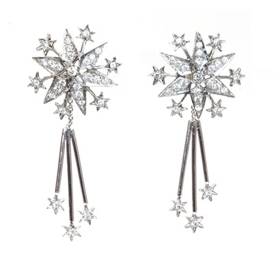 Lot 416 - A pair of 18ct white gold diamond set star burst drop earrings