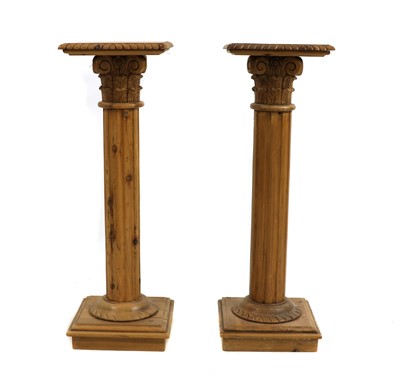 Lot 480 - A pair of polished pine torcheres