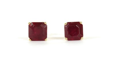 Lot 109 - A pair of gold single stone fracture filled ruby stud earrings
