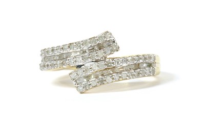 Lot 53 - A silver gilt diamond set crossover ring