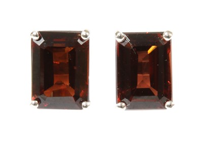 Lot 119 - A pair of white gold single stone garnet stud earrings