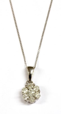 Lot 72 - A white gold diamond daisy cluster pendant