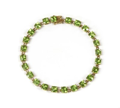 Lot 1261 - A gold peridot bracelet