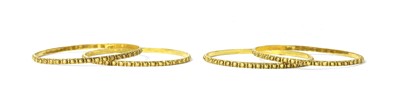 Lot 1157 - A set of four Indian high carat gold bangles