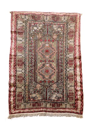 Lot 153 - A Turkish silk and gold-coloured metal rug