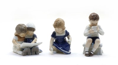Lot 161 - A Royal Copenhagen figure group of a boy and girl reading