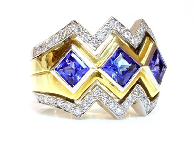 Lot 300 - A gold three stone tanzanite and diamond ring