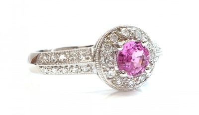 Lot 363 - An 18ct white gold pink sapphire and diamond halo cluster ring
