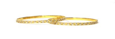 Lot 1158 - A pair of Indian high carat gold bangles