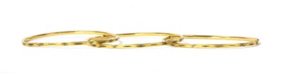 Lot 1160 - A set of three Indian high carat gold bangles