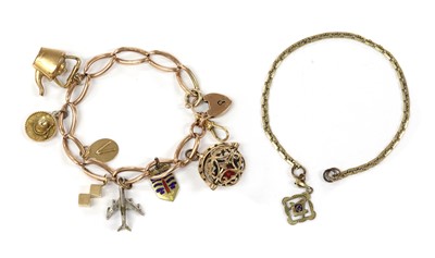 Lot 1100 - A gold charm bracelet